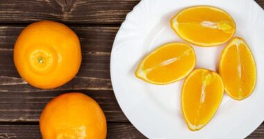 oranges and slices on plate, concept of orange peel hack