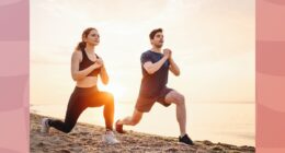 fit couple doing walking lunges on the beach at sunset