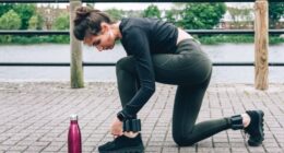 woman tying sneakers during walk with ankle weights
