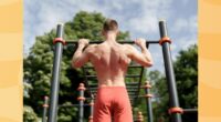 fit man doing pull-ups outdoors at park