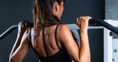 fit woman doing pull-ups