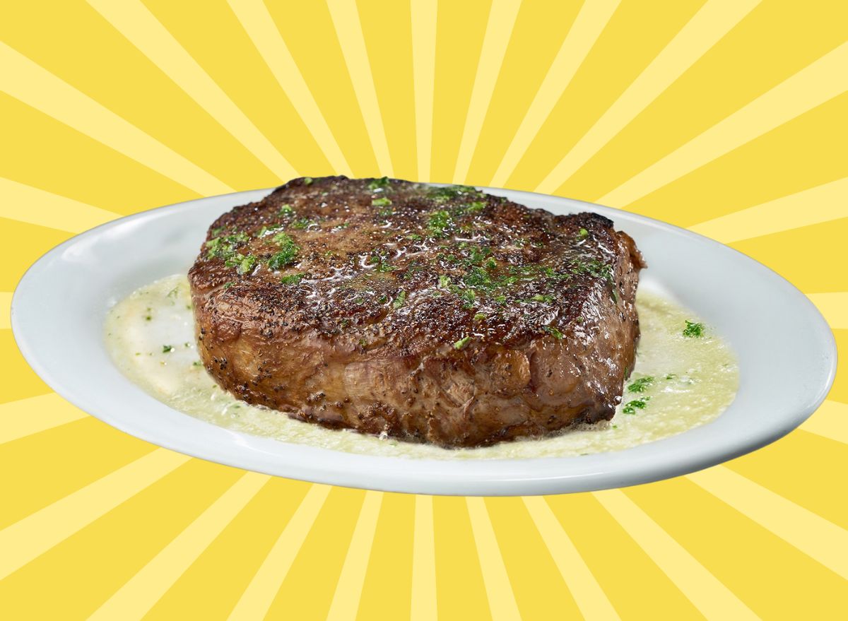 Broiled steak on a butter-drenched white plate at Ruth