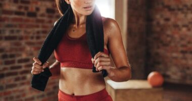 fit woman sweaty after workout looking in mirror, concept of easy changes to workout for better results