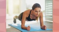 a photo of a woman doing a pilates plank on a designed pink background