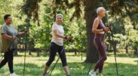 mature women with walking poles walking through nature for exercise