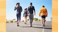 group of friends or fitness group doing a walking workout uphill