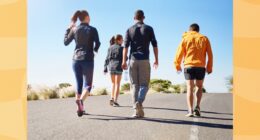 group of friends or fitness group doing a walking workout uphill