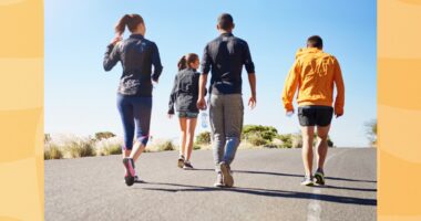 group of friends or fitness group doing a walking workout uphill