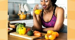 happy woman drinking homemade orange juice in her kitchen