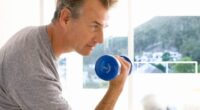 mature man lifting weights to slow down aging after 50