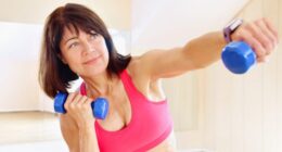 mature woman with dumbbells performing a breast lift workout