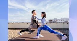 fitness couple doing lunges outdoors on rooftop workout space on sunny day