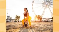 woman doing kettlebell squat exercise on the beach