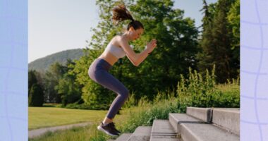 fit woman doing jump squat exercise on stairs outdoors