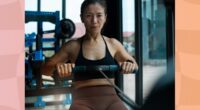 fit woman using rowing machine at the gym