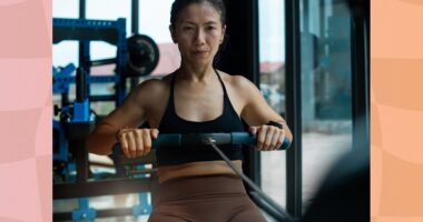 fit woman using rowing machine at the gym