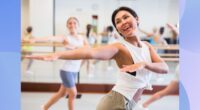 fit woman dancing in bright dance class studio