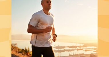 fit man jogging or running on a hilltop road at sunset