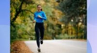 fit brunette woman running outdoors on street on brisk fall day