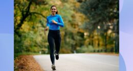 fit brunette woman running outdoors on street on brisk fall day