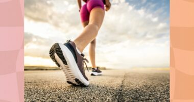 close-up of woman power walking on road on sunny day