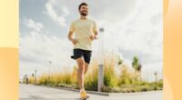 happy man running outdoors on paved path on sunny day