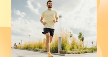 happy man running outdoors on paved path on sunny day