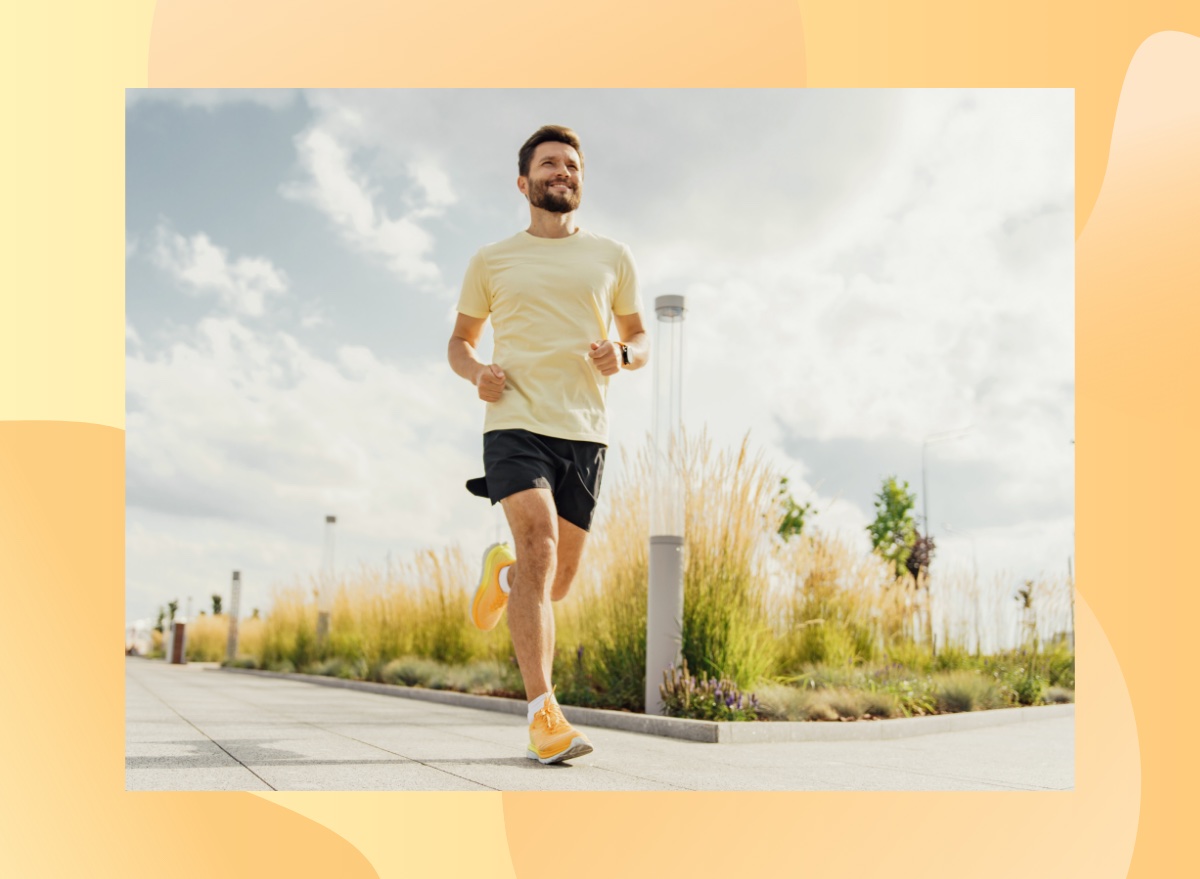 happy man running outdoors on paved path on sunny day