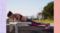 fit woman doing incline pushups outdoors at park