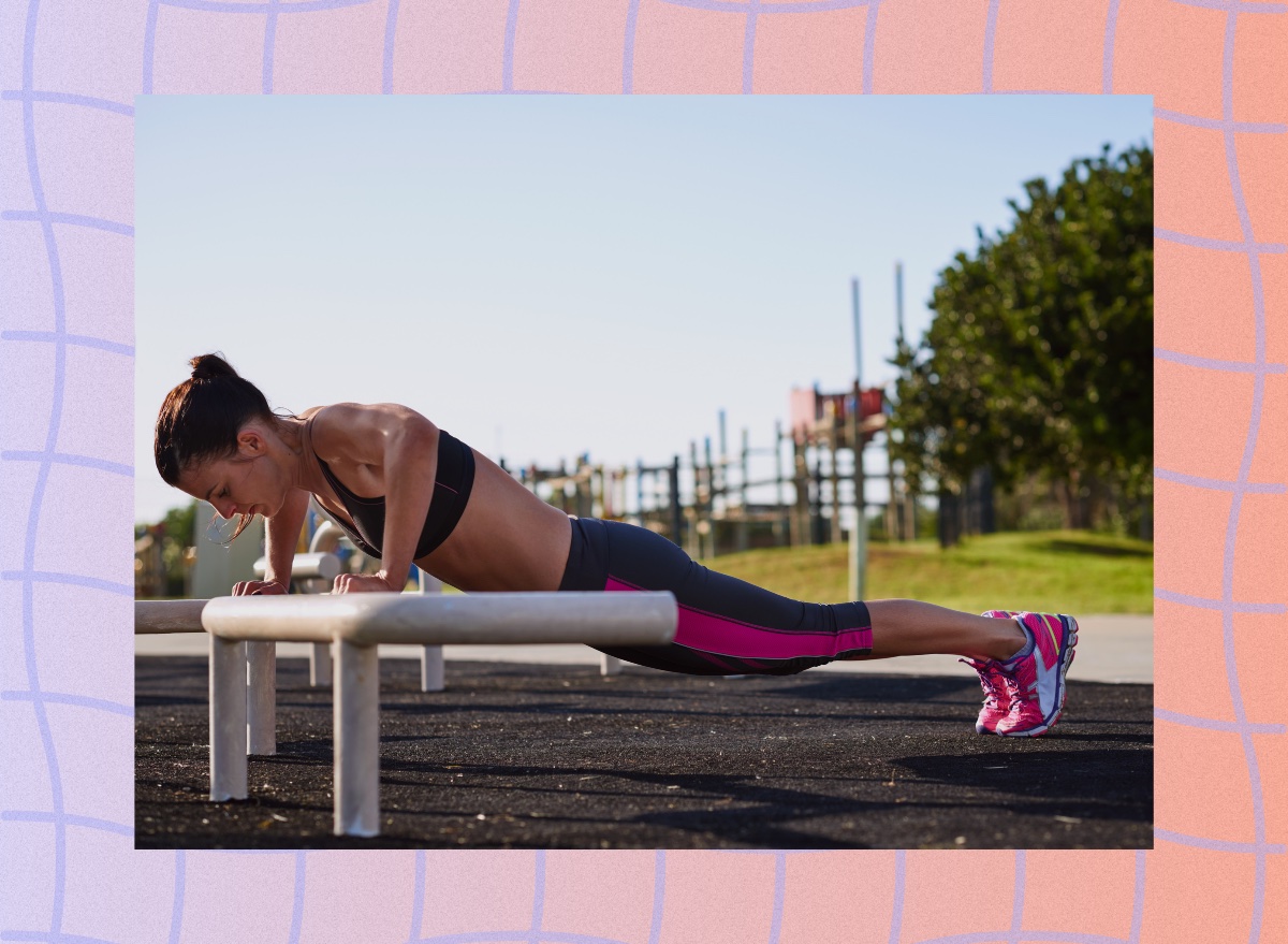 fit woman doing incline pushups outdoors at park