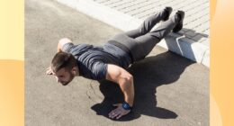 fit, muscular man doing feet-elevated pushups outdoors