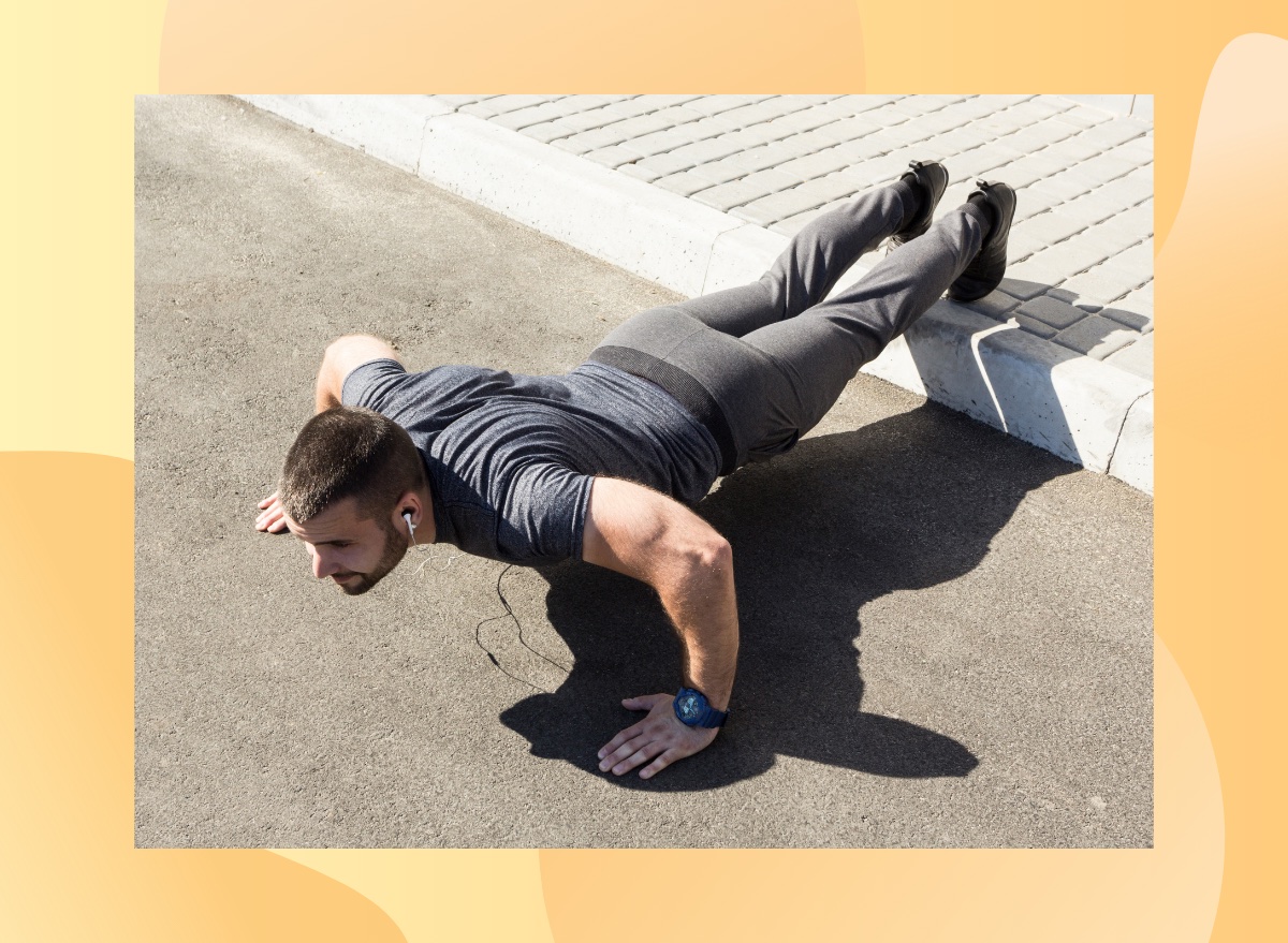 fit, muscular man doing feet-elevated pushups outdoors