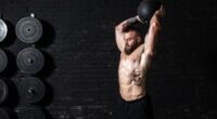 muscular man medicine ball slam, concept of ab workouts for men