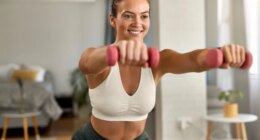 fit woman doing hourglass body workout at home, bright living room