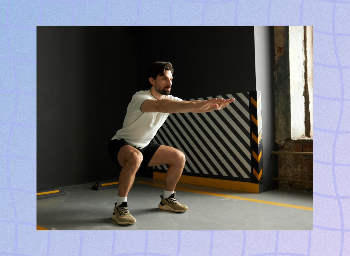 man doing squats at the gym