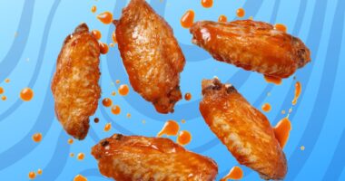 A quintet of saucy Buffalo-style chicken wings set against a vibrant swirly blue background