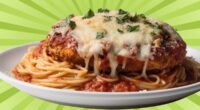 A plate of chicken parmesan over spaghetti set against a colorful background.