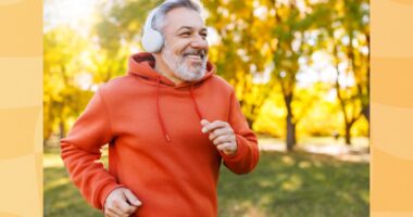 fit, mature man running outdoors on fall afternoon through the park