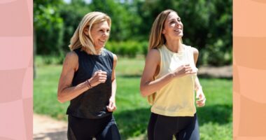 two fit, happy middle-aged woman walking outdoors on a sunny day