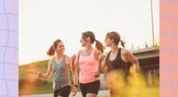 three fit friends walking outdoors for exercise on sunny late afternoon