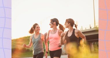 three fit friends walking outdoors for exercise on sunny late afternoon