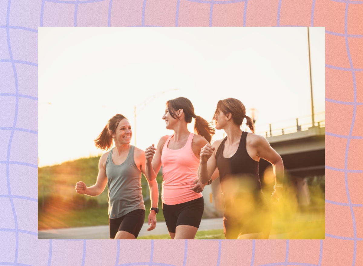 three fit friends walking outdoors for exercise on sunny late afternoon