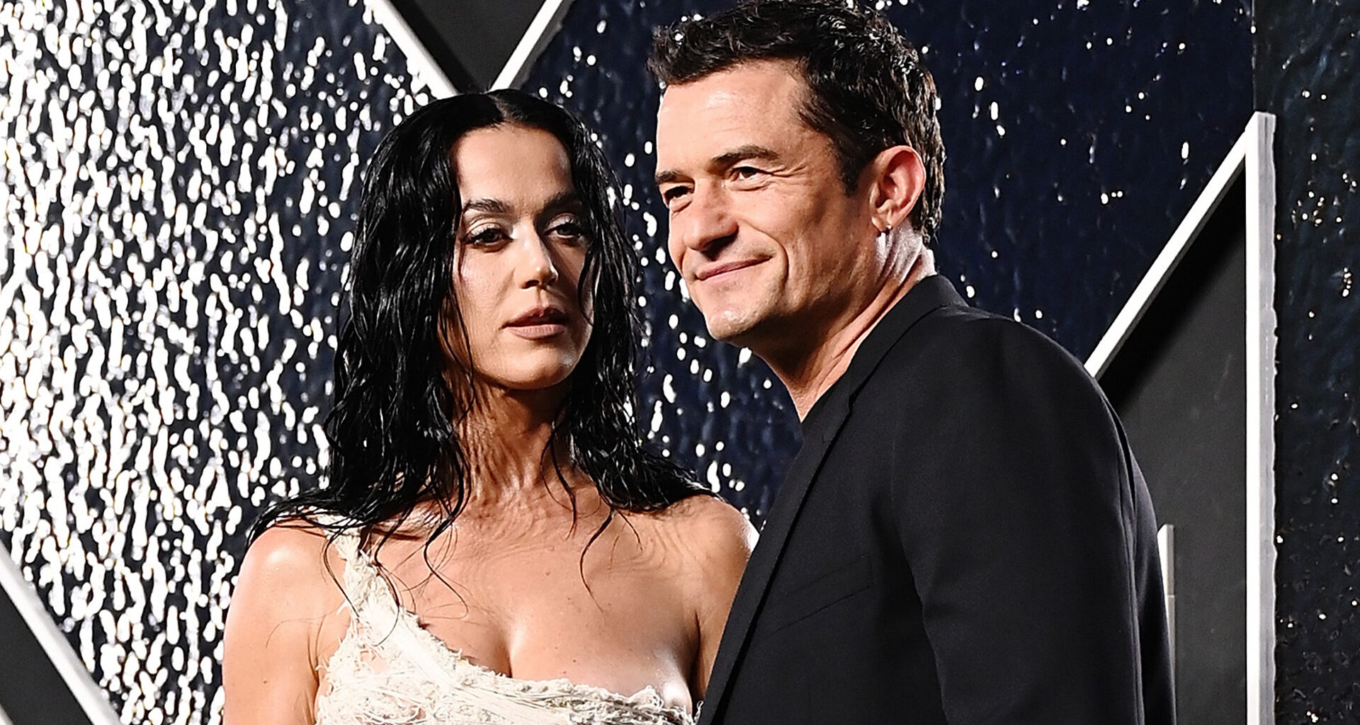 Katy Perry fans say she’s ‘aging backwards’ as star shows off abs and QR code back tattoo at MTV VMAs with Orlando Bloom