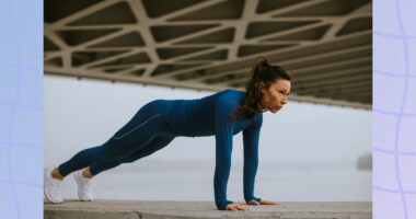 fit, focused brunette woman doing pushups outdoors under bridge