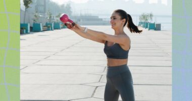 fit woman doing kettlebell swing exercise outdoors