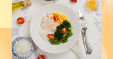 a healthy, portion-controlled plate with rice, chicken, broccoli, and corn