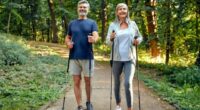 happy, mature couple doing Nordic walking on hiking trail