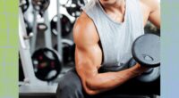 close-up of muscular man doing a seated bicep curl at the gym