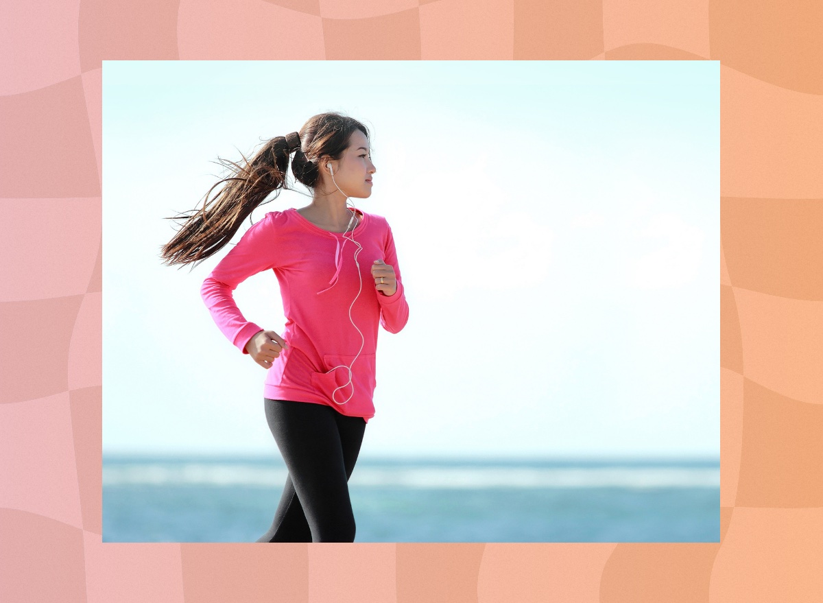 woman power walking on the beach on clear, sunny day