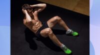 muscular man doing crunches on black workout mat